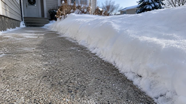 A full-width walkway cleared cleanly to the concrete, with snow set back from its edges